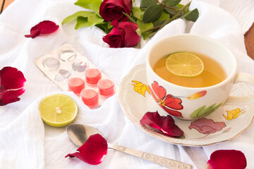 herbal healthy drinks hot honey lemon for health care sore throat with flowers rose arrangement flat lay style on background white