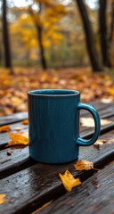 Blue Mug on Wooden Bench with Autumn Leaves