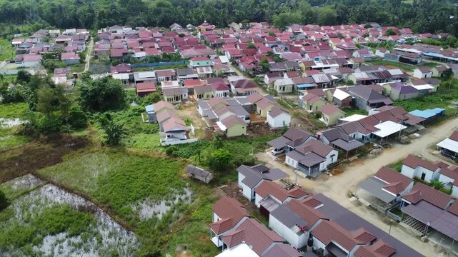 Aerial view of a residential area, some of which is still under construction, surrounded by agricultural areas