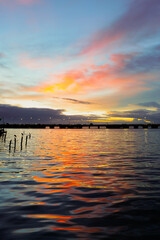 sunset in the sea. Beautiful colorful sky and cloud in twilight time background. Orange fluffy clouds and sun sunlight reflection in the blue sky. 