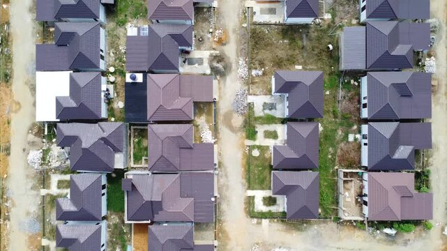 Aerial view of a residential area, some of which is still under construction, surrounded by agricultural areas