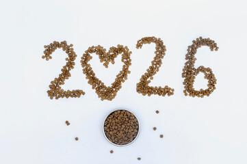 Calendar 2026 from Dry pet food on a white background. Granules of good nutrition for dogs and cats. Food for the animals. Brown homogeneous pieces of dry food in the shape of numbers
