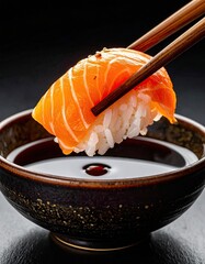 Salmon nigiri sushi, dipping in soy sauce
