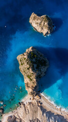Stunning top aerial view of Myzithres Zakynthos Greece with sharp cliffs turquoise beach white sand and endless deep blue sea surrounding the coast