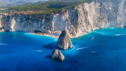 Aerial photo of Myzithres Zakynthos Greece with twin limestone rocks turquoise water dramatic cliffs and long coastline stretching in sunlight