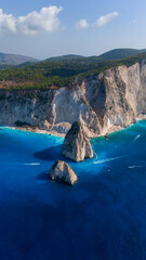 Myzithres Zakynthos Greece coastline aerial showing steep cliffs turquoise bays sandy coves and iconic twin rocks rising from the blue sea