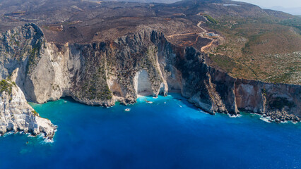 Aerial panorama photo of Paltakis beach Zakynthos Greece showing dramatic white cliffs turquoise Ionian Sea hidden sandy bay and rocky arch formations