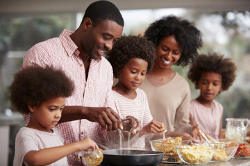 joyful family gathers in cozy kitchen preparing steaming herbal teas together