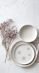 Set of minimalist, off-white plates and bowl with dried flowers