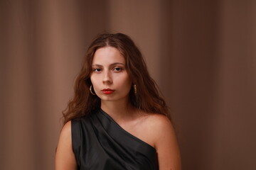 Close portrait of young pretty woman on brown background