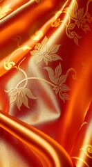 オレンジ色生地のクローズアップ ゴールドの装飾模様