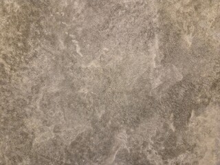 Close-up, texture shot of a grey concrete or plaster surface.