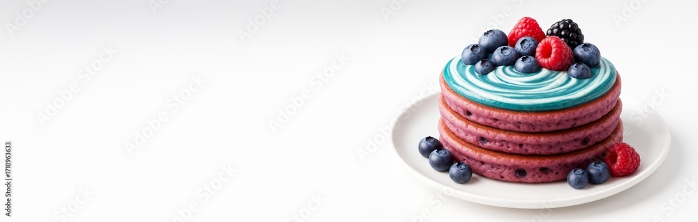 Poster stack of berry pancakes with blue swirl frosting and mixed berries on white plate, isolated on clean