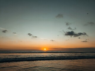 Seascape view during golden hour with calm waves.