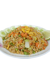 Appetizing vegetarian fried rice with egg, garnished with fresh cucumber slices and vibrant lime wedge. delightful and colorful dish for enjoyment