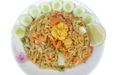 Flavorful vegetarian fried rice featuring golden egg, expertly garnished with crisp cucumber slices and bright lime wedge. appealing dish offers satisfying culinary experience