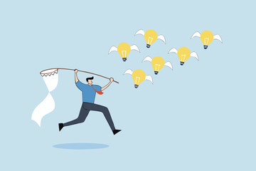 Capture new business ideas, businessman hunts and catches ideas to fly light bulbs with butterfly net.