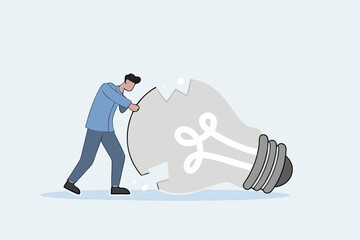 depressed businessman standing with old broken light bulb idea that failed miserably.