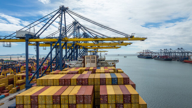 Aerial view container cargo ship international port terminal with gantry crane, industrial cargo container port loading and unloading, Global business logistic import export frewight shipping.