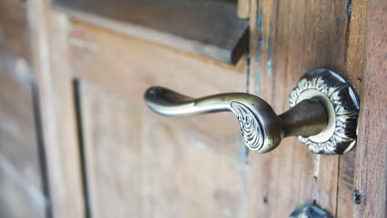 Classic Ornate Door Handle on a Weathered Wooden Door