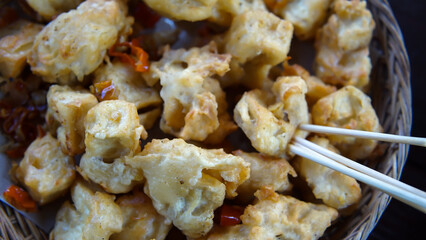 Close up of Crispy Fried Tofu with Chili in a Woven Basket