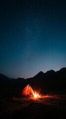 A glowing tent illuminated by a campfire under a vast, star-filled night sky in a mountainous landscape.