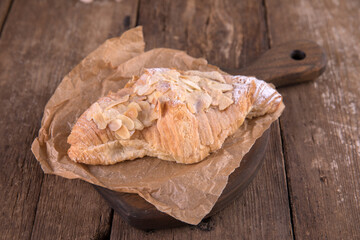Almond croissant on a wooden background