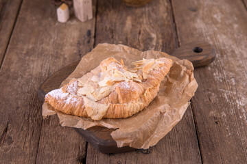 Almond croissant on a wooden background