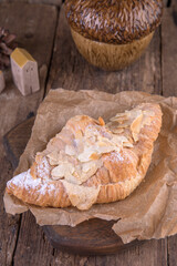 Almond croissant on a wooden background