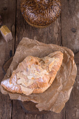 Almond croissant on a wooden background