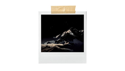 Vintage instant photo of a mountain range at night.  A light beige, slightly textured instant photo frame 