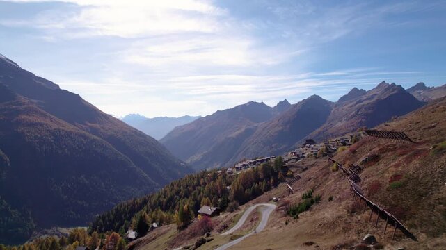 Flying towards a valley with conifer trees in autumn, L&ouml;tschental, Switzerland