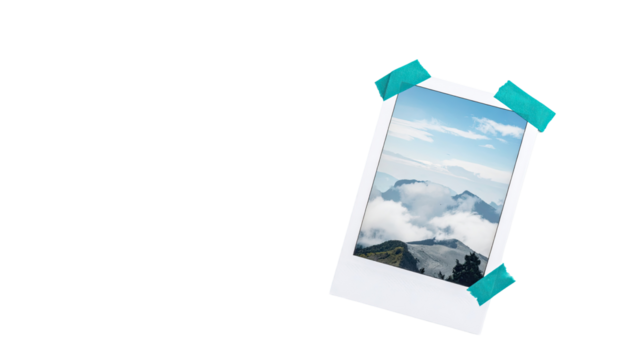 A tilted instant photo, showcasing a mountain landscape with clouds, affixed with teal-colored tape