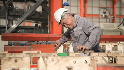 Industrial worker in protective gear experiencing chest pain while working