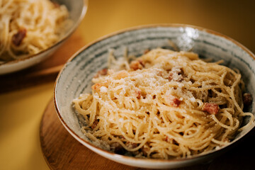 Delicious pasta bolognese served in stylish bowls at a cozy dining table