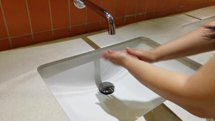 A thorough handwashing demonstration for health and hygiene at a modern vanity.
