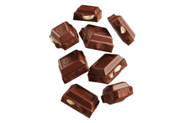 Fototapeta premium Multiple pieces of milk chocolate with hazelnuts levitate against a transparent background. background removed
