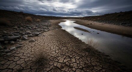 Cracked Earth Meets Reflective River Under Dramatic Cloudy Sky Landscape