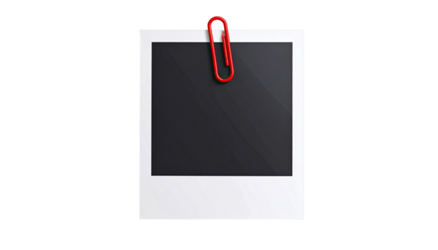 A blank, white, instant photo frame, attached to a black background with a red paperclip