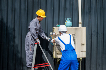 Engineers Servicing AC Unit: Two skilled engineers collaborate harmoniously, conducting essential maintenance on an air conditioning unit.