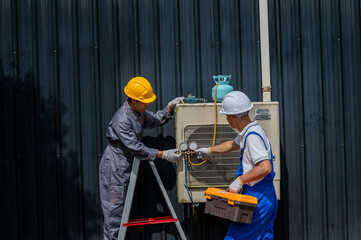 HVAC Technicians at Work: Two skilled HVAC technicians in protective gear meticulously service an air conditioning unit, showcasing their expertise.