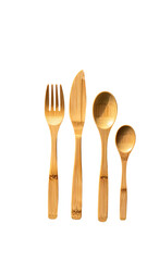 Four light-brown bamboo utensils?fork, knife, large spoon, small spoon?arranged vertically against a black background