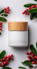 A minimalist, elegant product display of a white cosmetic container with a light brown bamboo lid, surrounded by red berries and green leaves on a neutral background.