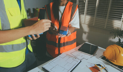 Closeup of team of industrial engineers meeting analyze machinery blueprints consult project on table in manufacturing factory. Working in manufacturing plant or production plant.