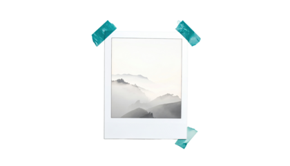 A white instant photo frame, featuring a misty mountain landscape, bordered with teal colored tape