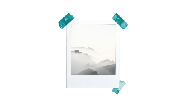 A white instant photo frame, featuring a misty mountain landscape, bordered with teal colored tape