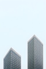 Obraz premium Minimalist Skyscraper Architectural Symmetry: Two Modern Buildings Against a Pale Sky