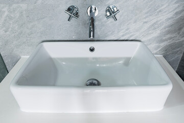 Ceramic white basin on top counter in bathroom