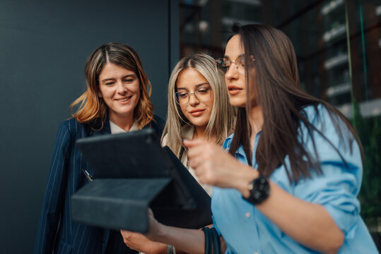 Businesswomen using tablet for a meeting outdoors