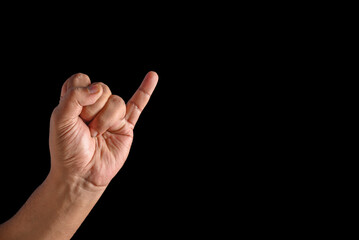 Close-Up of Hand Making a Gesture with Showing only Little Finger Raised on a Black Background